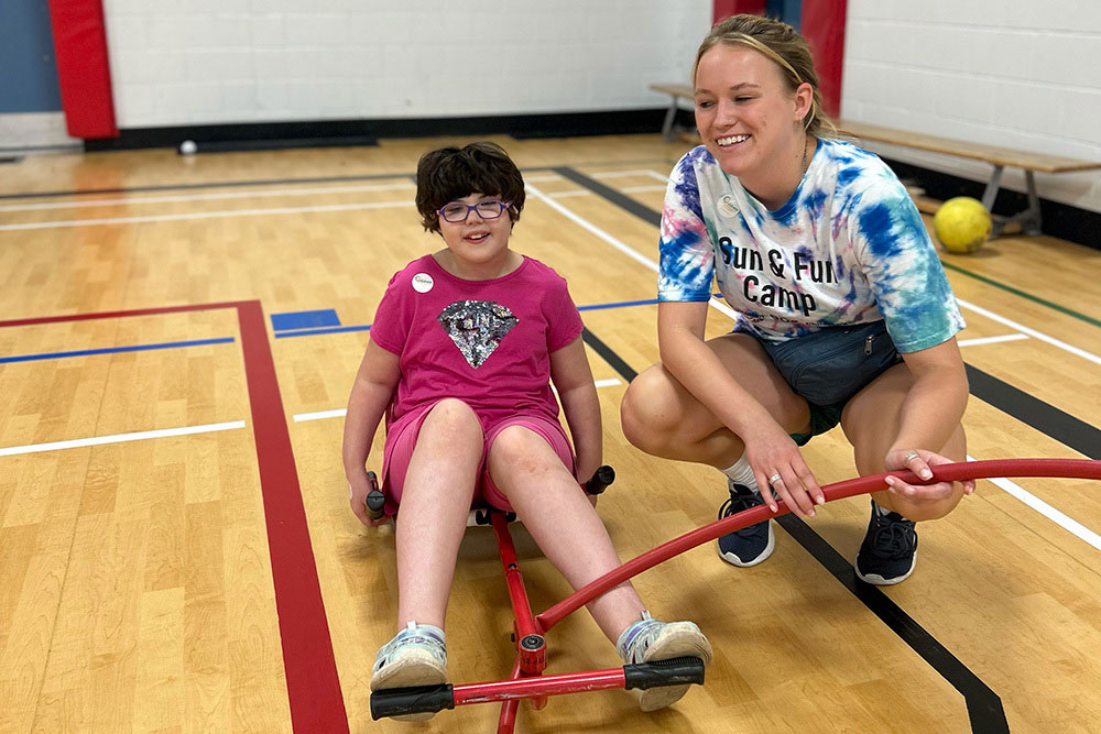 child sitting on gym floor