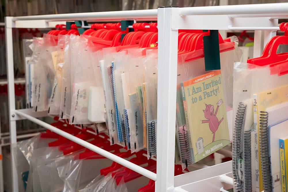 row of library books hanging in bags