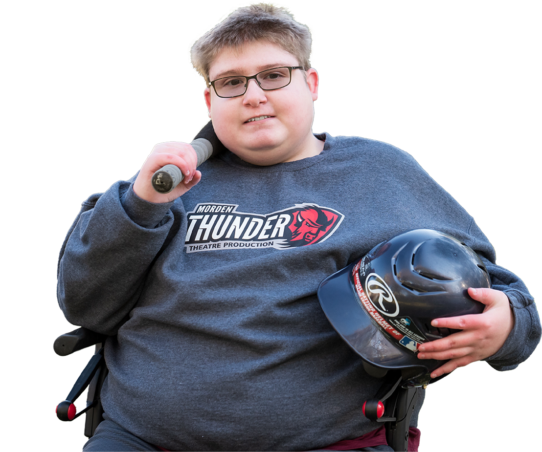 Boy named Evan smiling while holding a baseball bat and helmet in hand