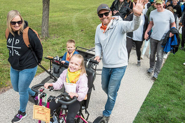 family walking outside at Cruisin' to change lives event