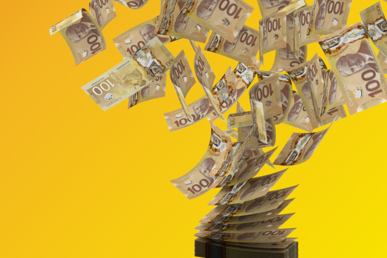 One hundred dollar Canadian bills flying in air.